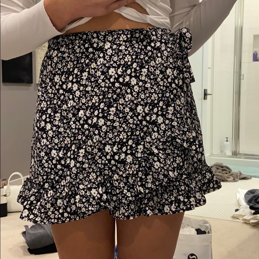 A floral black skirt with white flowers.
